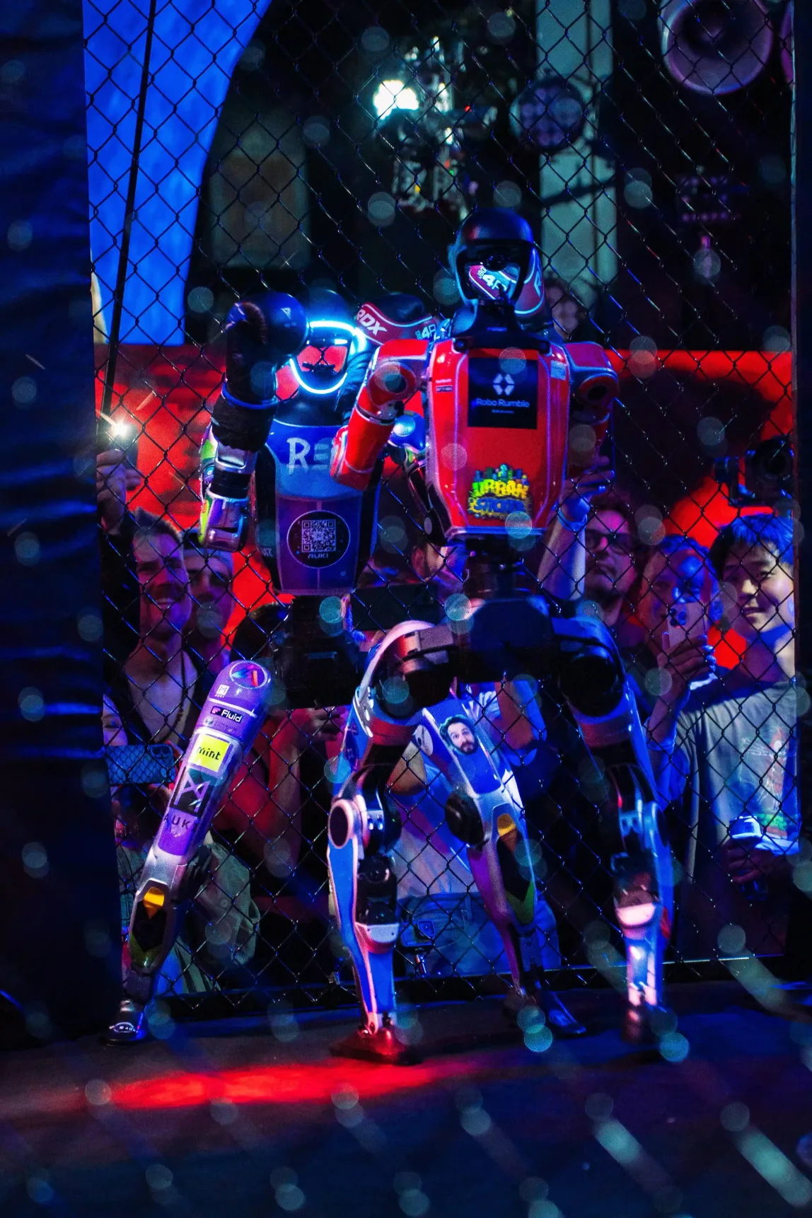 REK robot at a live event, crowd behind the wire