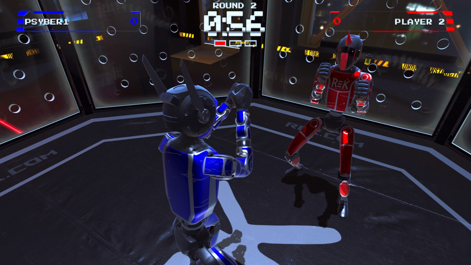 Two robots facing off in the REK simulator, round timer and scores on screen